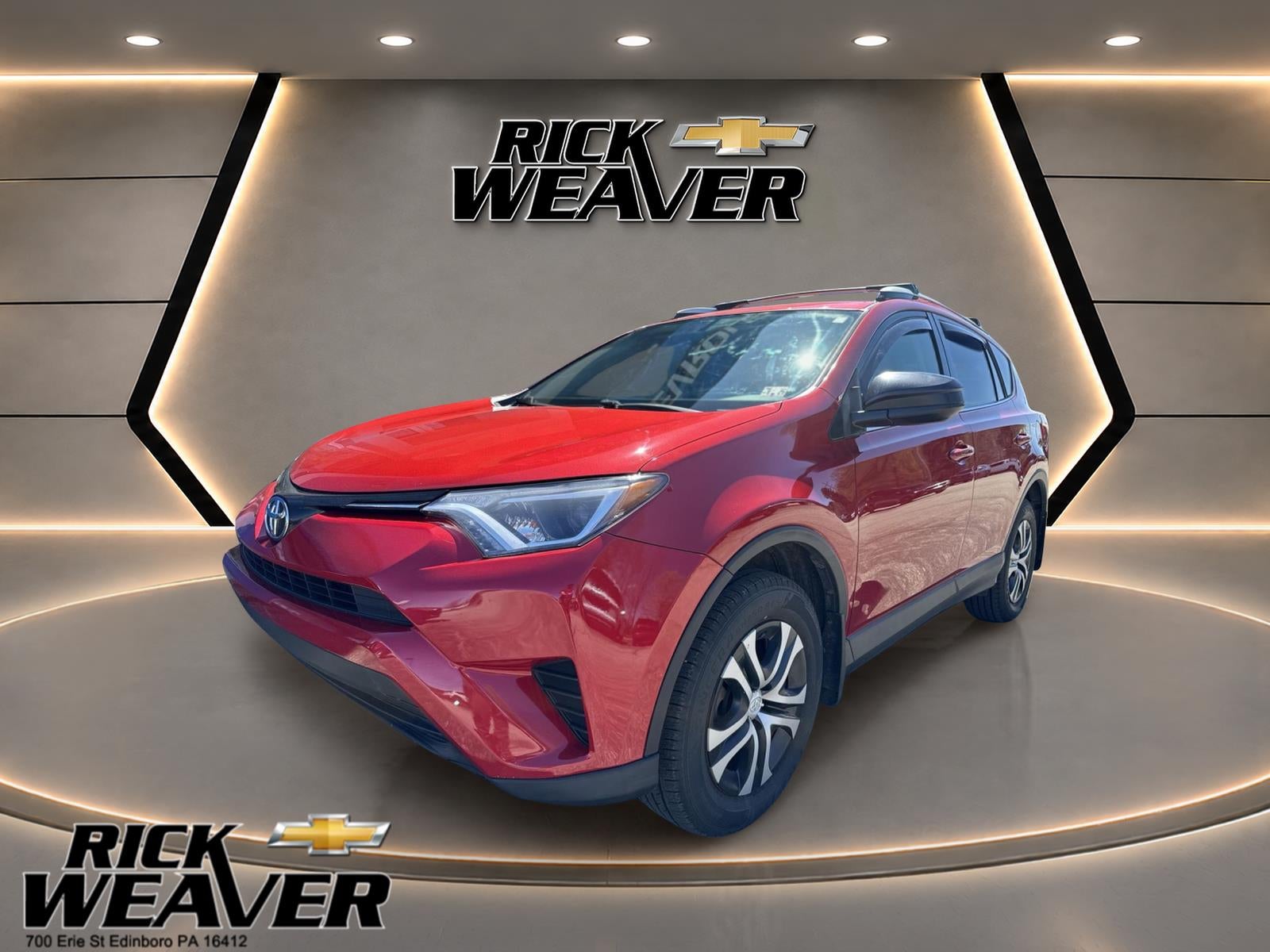 2016 Toyota RAV4 LE in Red — front three-quarter view